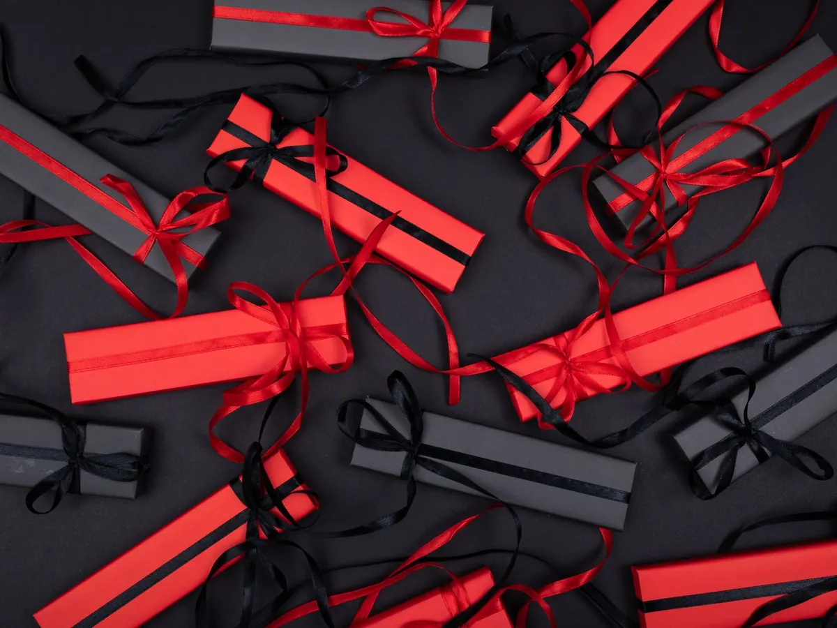 Gift boxes wrapped in red and black ribbon